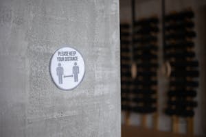 Please Keep Your Distance title on sign in gym