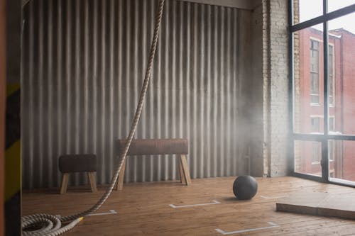 Battle rope and slam ball on floor in gym