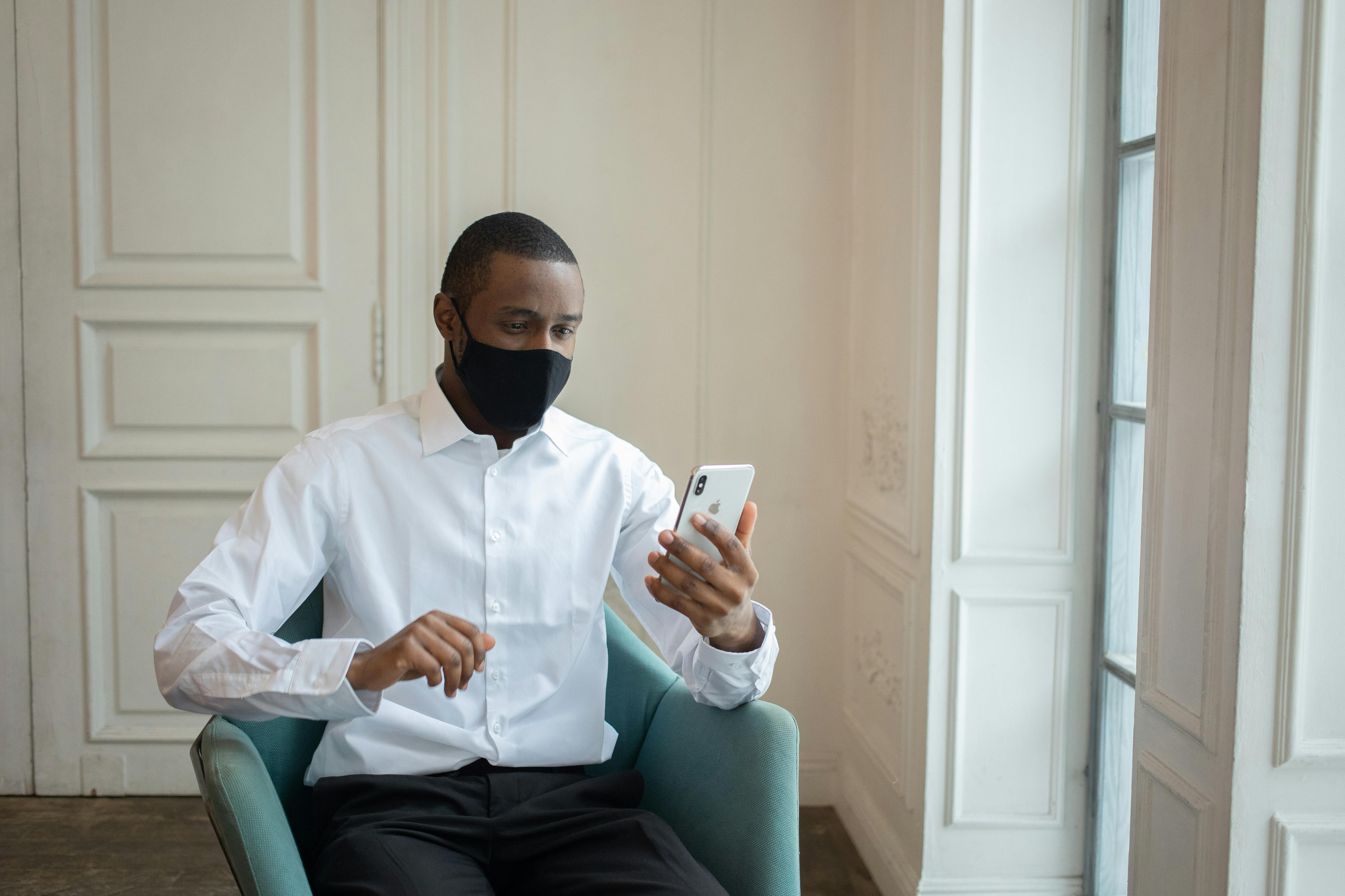 african american businessman having video call on smartphone in workspace