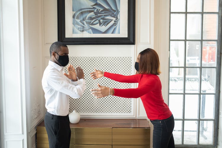 Black Boss In Fabric Mask Showing No Gesture Against Partner