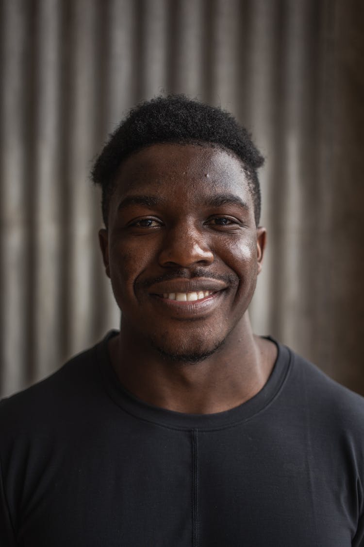 Cheerful Black Man On Gray Background