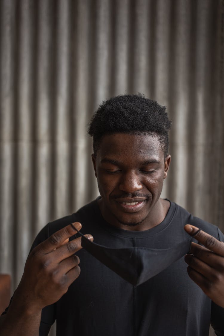 Black Man Putting On Protective Mask