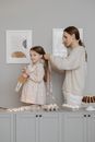 A Mother Tying Her Daughter's Hair with a Ribbon