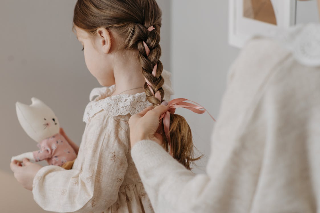Free Photo of a Person Braiding a Girl's Hair Stock Photo