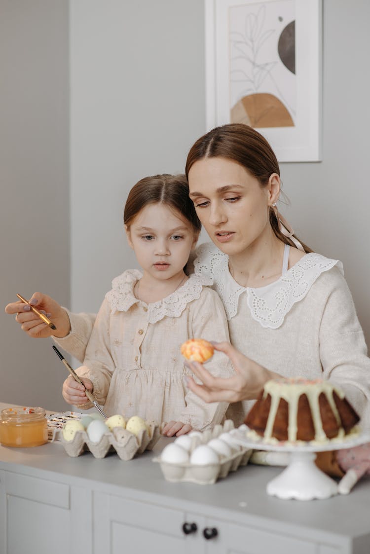 Mom And Daughter Painting Easter Eggs