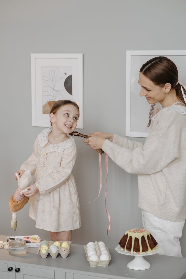 Photo Of A Mother Braiding Her Daughter's Hair