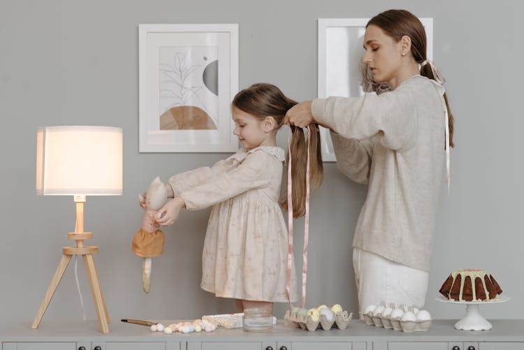 Photo Of A Woman Braiding A Kid's Hair