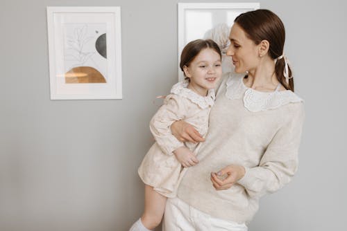 Free Photo of a Mother Carrying Her Cute Daughter  Stock Photo