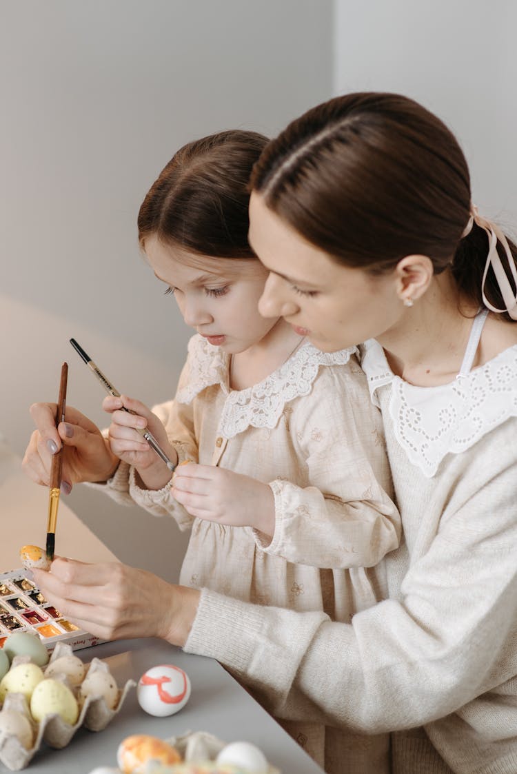 Woman And Child Painting Eggs