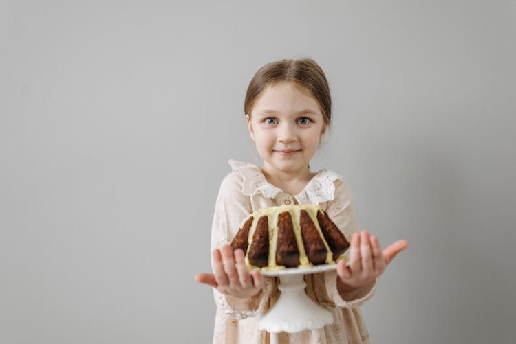 A Girl Holding A Cake