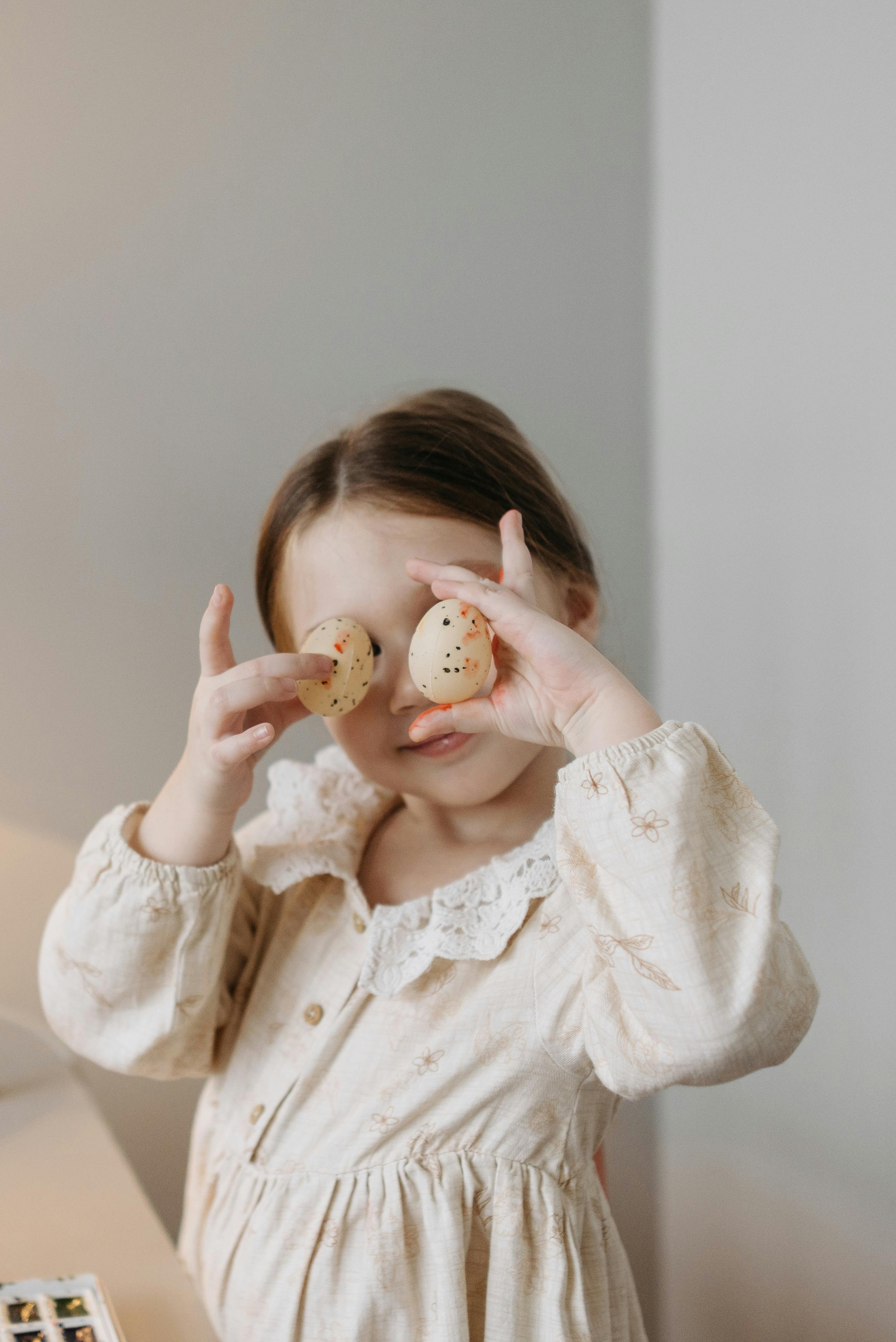 photo of a girl holding easter eggs