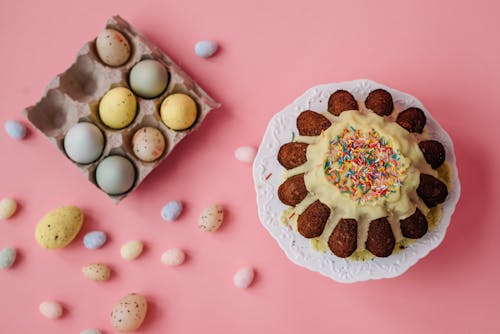 Flat Lay Photography of Easter Eggs and Cake on Pink Surface