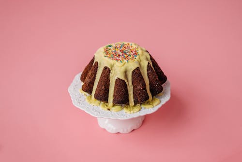 A Delicious Chocolate Cake Topped with Cream and Sprinkles