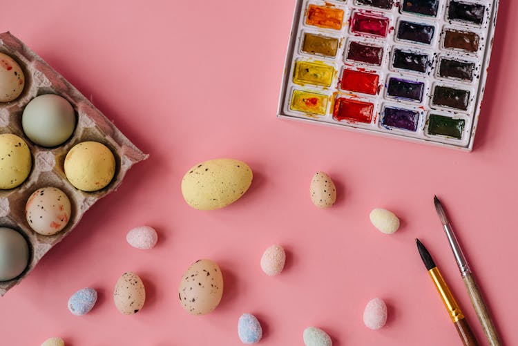 Quail Eggs And Watercolors On A Pink Surface