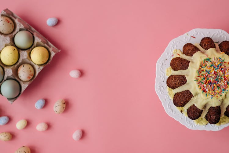 Overhead Shot Of A Bundt Cake Near A Tray Of Easter Eggs