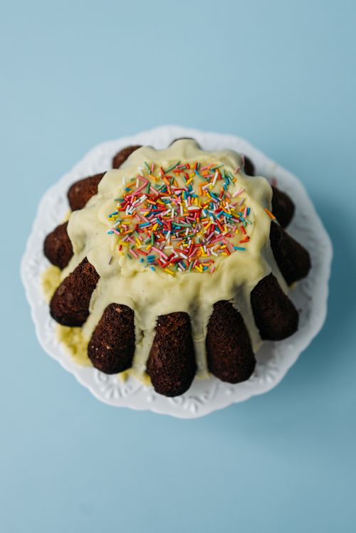 Free Delicious Bundt cake topped with colorful sprinkles and icing, perfect for celebrations. Stock Photo