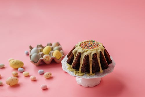 Easter Eggs and Cake on Pink Background