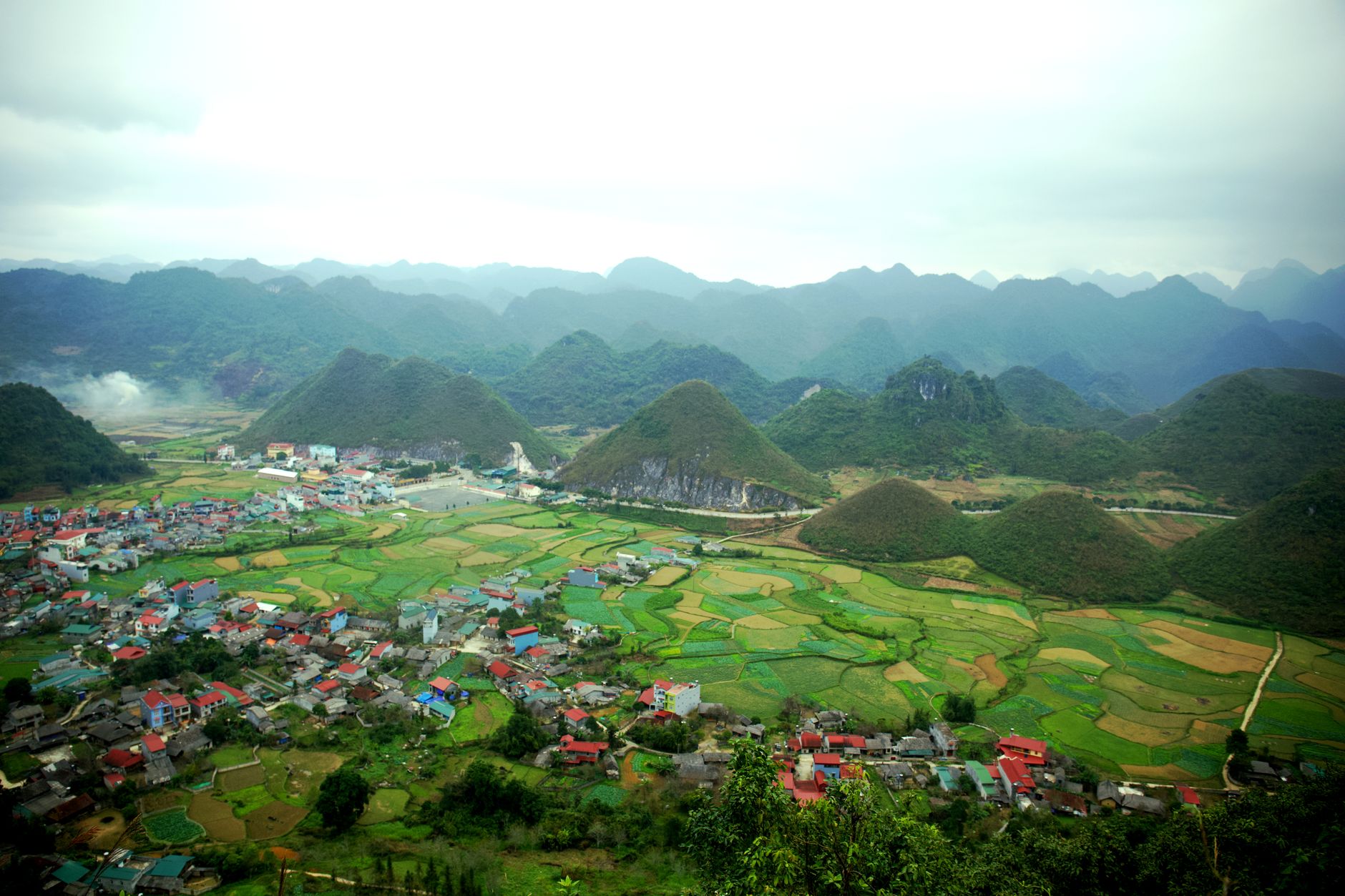 The rounded Twin Mountains rising from the fields and rooftops of Tam Son town, seen from the Quan Ba Heaven Gate viewpoint