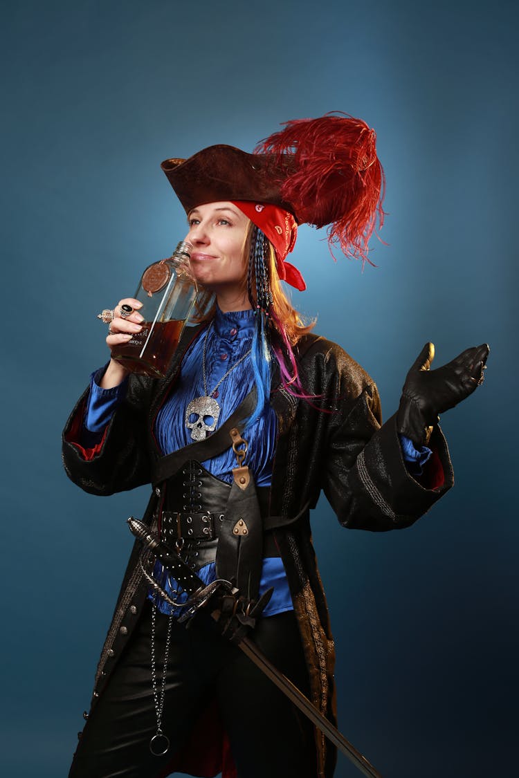 Cheerful Model In Pirate Costume Smelling Rum