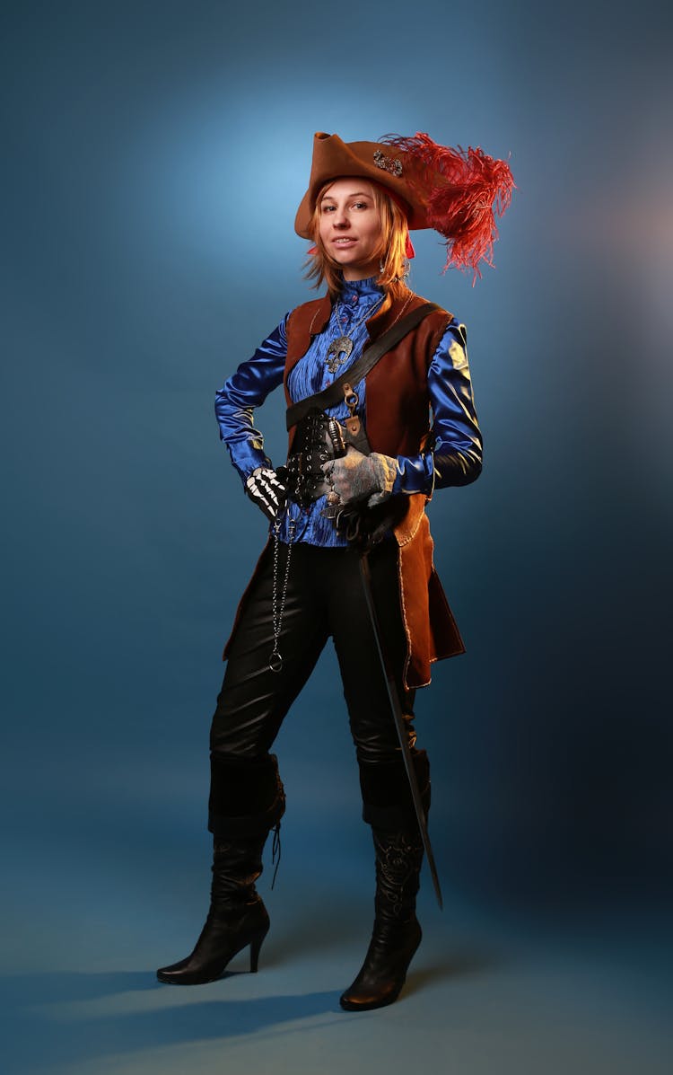 Model In Pirate Costume On Gray Background