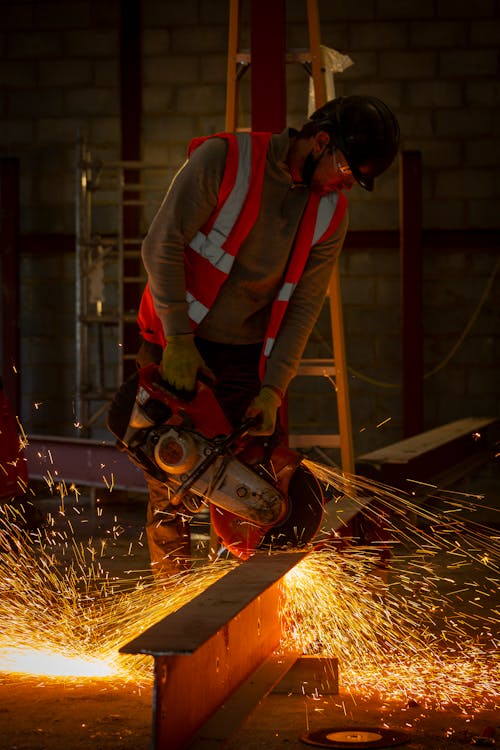 Free Man Using a Metal Cutting Saw at Work Stock Photo