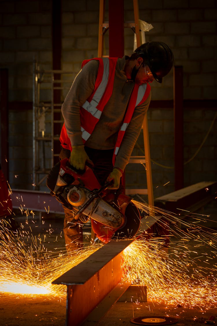 Man Using A Metal Cutting Saw At Work