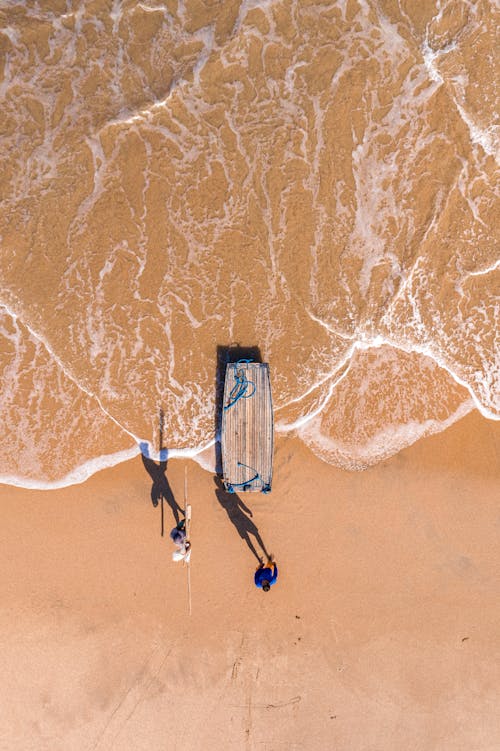 Aerial Photography of Two People on the Sea Shore