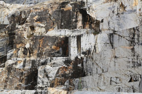 Close inspection of raw Carrara marble at the quarry face