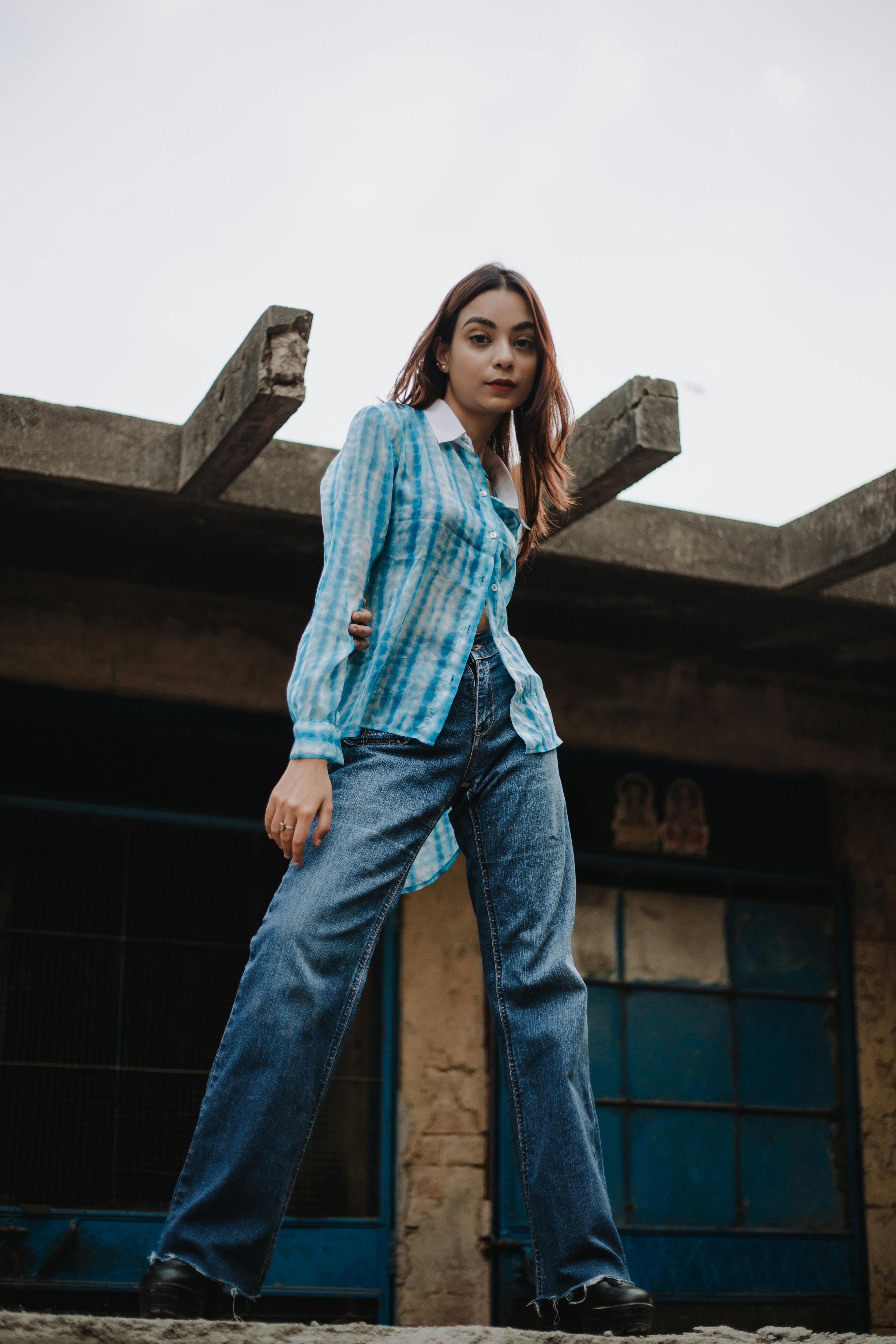 Happy young woman in plaid shirt and jeans posing Royalty-Free Stock Image  - Storyblocks
