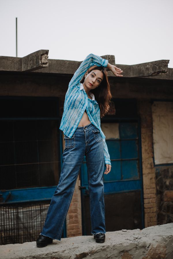 woman wearing tie front top and flare jeans