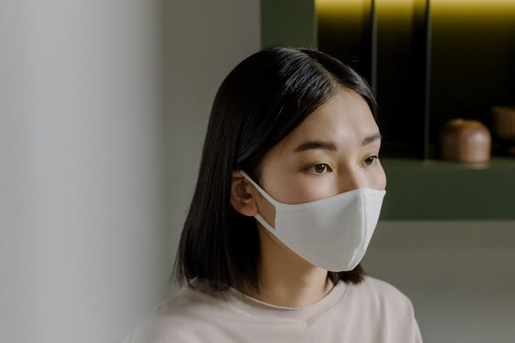 Girl Wearing Her White Face Mask
