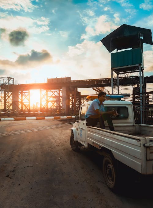 Free Man Sitting at Back of a Pickup Truck Stock Photo