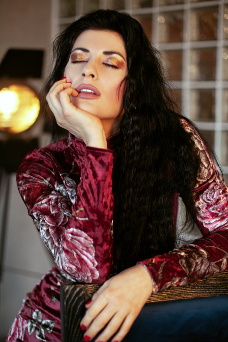 Mindful Woman With Makeup Touching Lips At Home