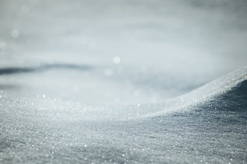 Glowing crystals in sandy dunes in hot desert terrain lightened by bright sunshine