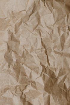Close-up of crumpled brown paper texture ideal for backgrounds and design projects.