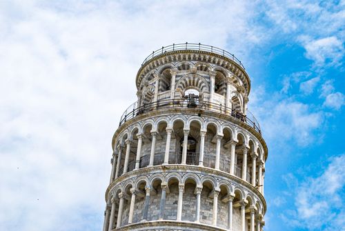 Free Close-up of the Leaning Tower of Pisa's architectural details against a bright sky, capturing its iconic tilt. Stock Photo