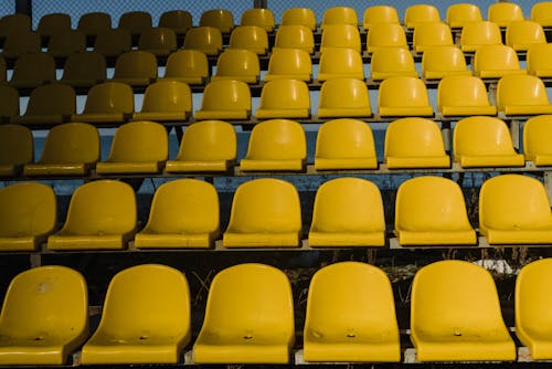 Free Yellow Plastic Seats on the Bleachers Stock Photo