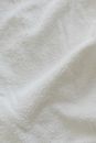 Top view soft white terry cloth with crumbles placed on table in bright light