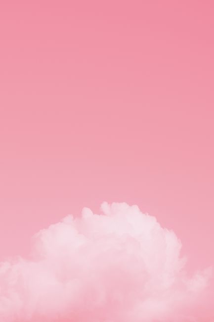 Bright pink colorful sky with white soft fluffy cumulus clouds floating in daylight