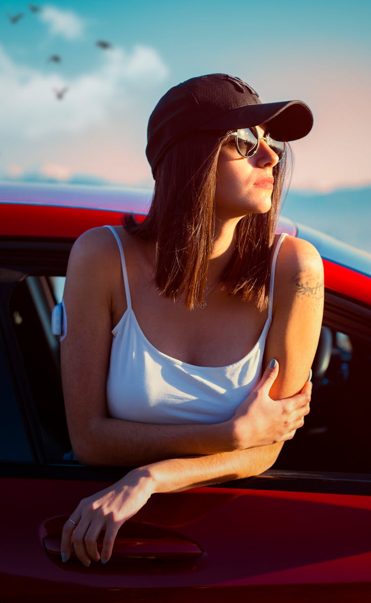 Woman In White Tank Top Leaning Out The Car Window