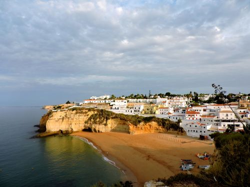 Free Beautiful coastal village with white buildings on a cliff overlooking a serene beach. Stock Photo
