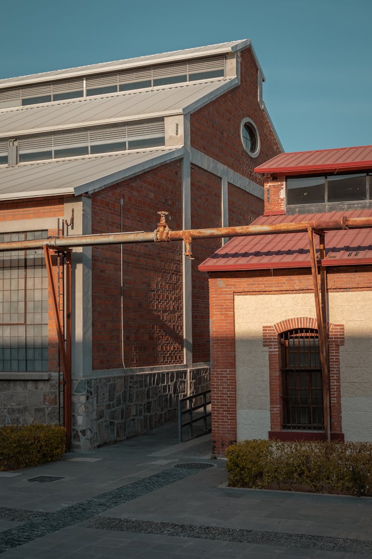 Steel Pipes Near Brick Buildings 