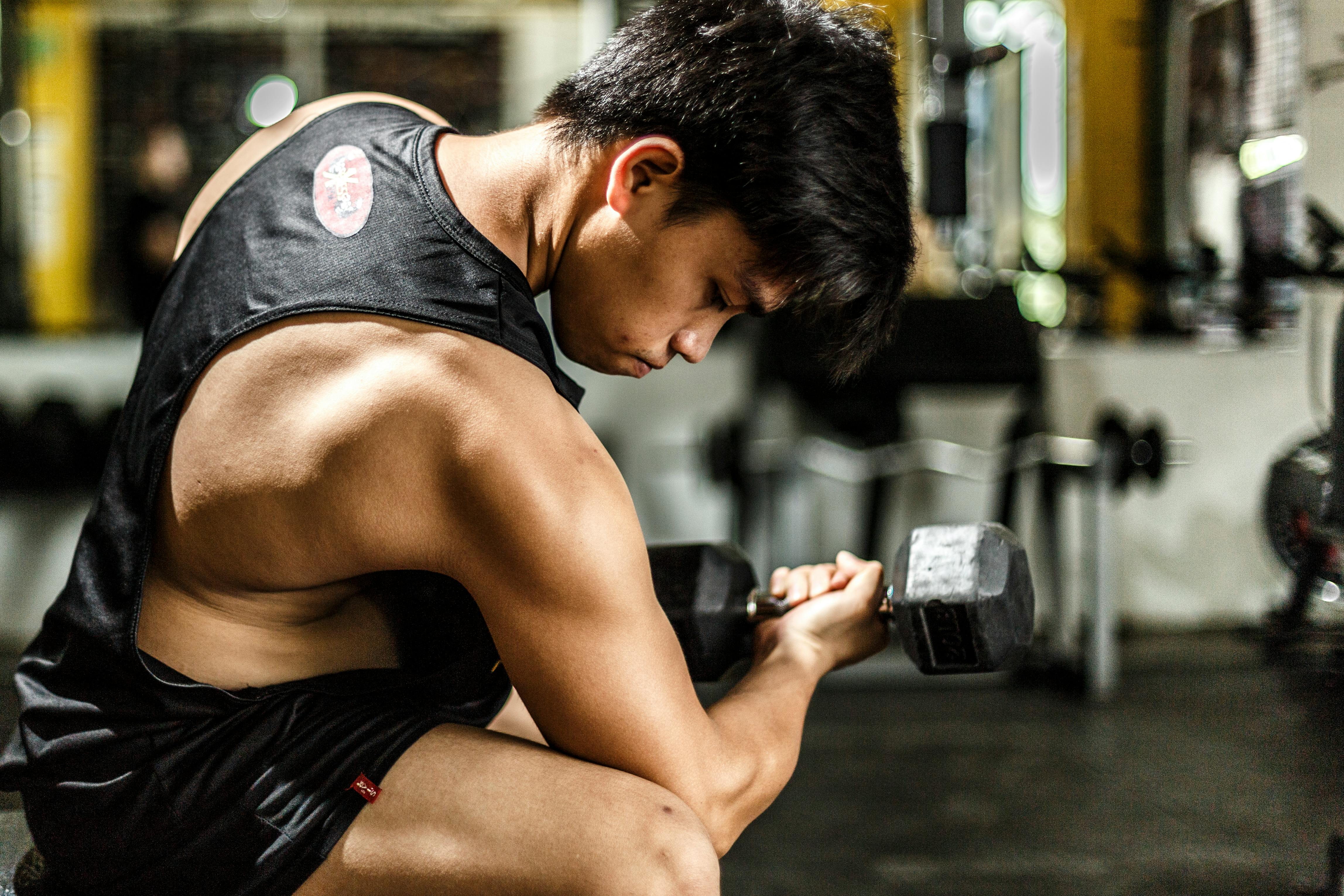 woman wearing black tank top taking work out