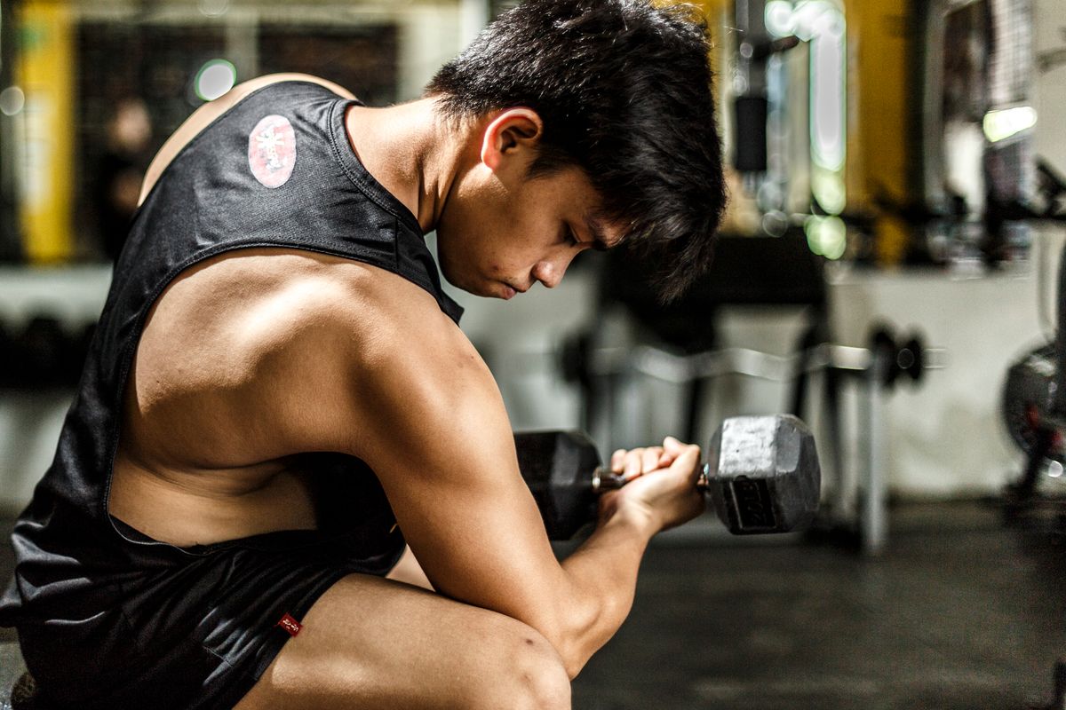 Man working out with dumbbells in the gym