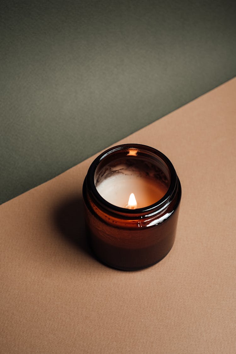 A Lighted Candle In A Jar