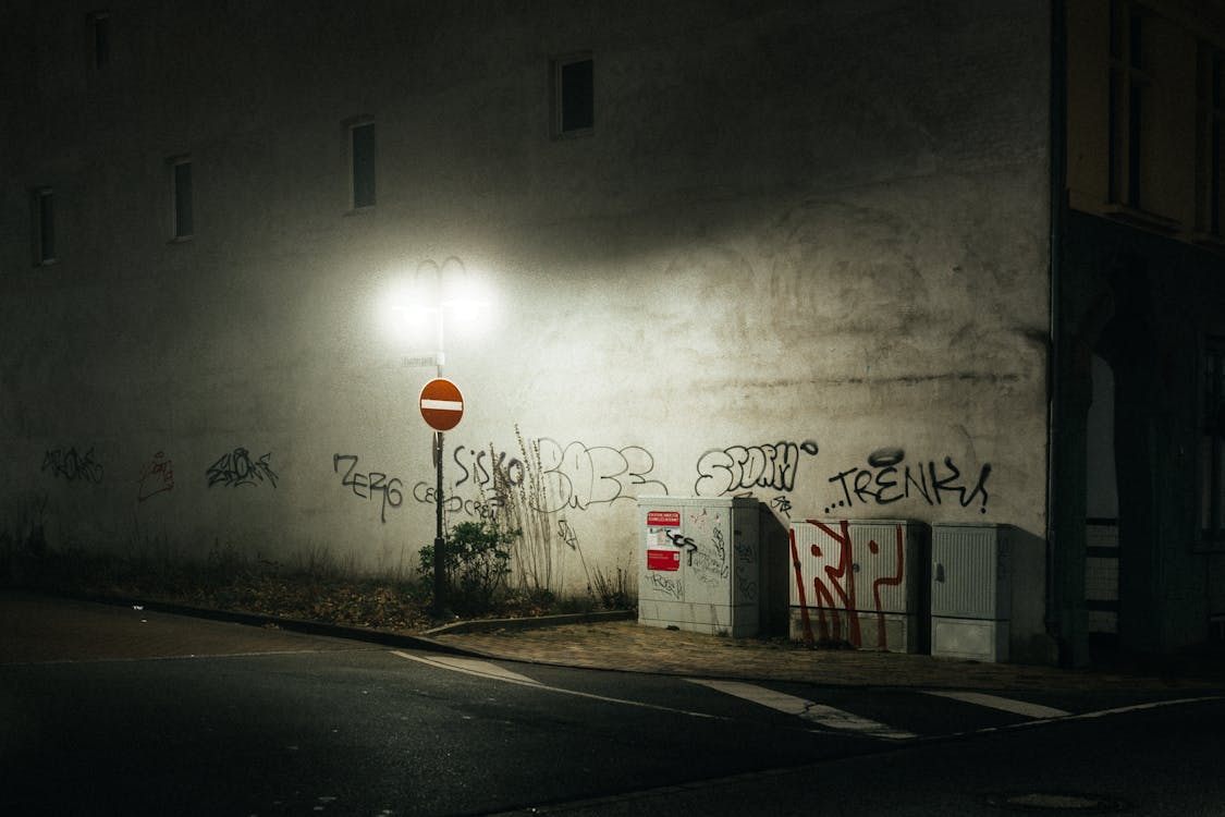 Free 
A Wall with Graffiti Illuminated by a Street Lamp Stock Photo