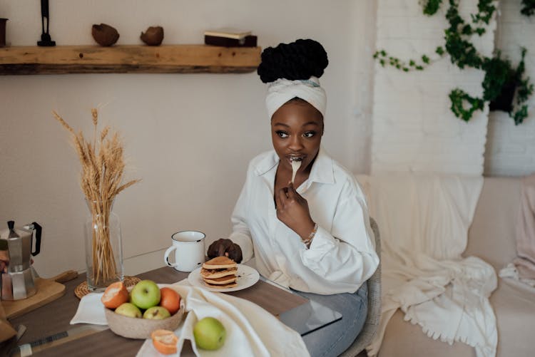 A Beautiful Woman Eating Pancakes