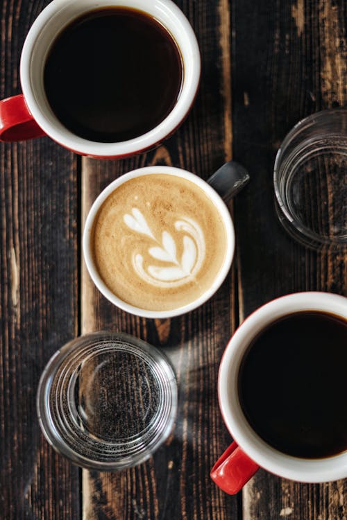 
A Flatlay of Brewed Coffees and a Latte