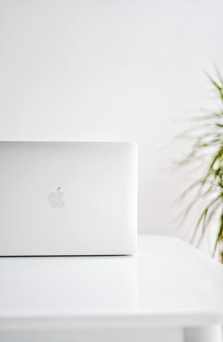 An Apple Laptop On White Table