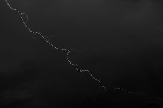 Captivating lightning bolt cuts through dark night sky showcasing nature's power.